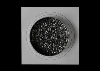 Lead pellets for air rifle, aluminum box and paper target isolated on black  