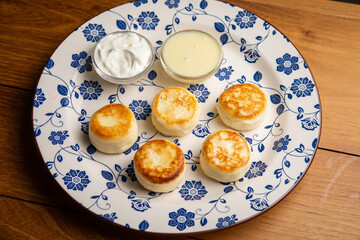 pancakes with sour cream and cheese on a plate