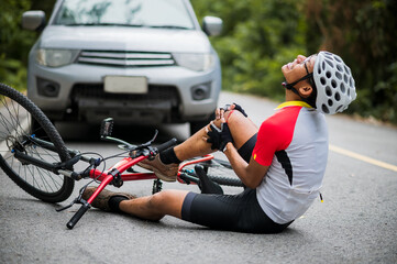 An Asian mountain biker was hit by a car on the road. A mountain biker was injured in a collision...