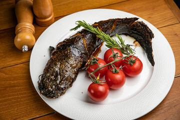 Fish dish with garnish on a plate in a restaurant
