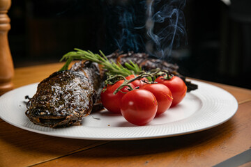 Fish dish with garnish on a plate in a restaurant
