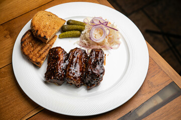 Food. Grilled Meat And Vegetables With Sauce Closeup. Grilles Pork Ribs In Restaurant.