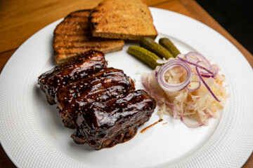 Food. Grilled Meat And Vegetables With Sauce Closeup. Grilles Pork Ribs In Restaurant.