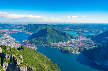 Fototapeta na wymiar The city of lecco, shot from above, by day, with the surrounding mountains. 