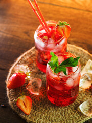 Two glasses of strawberry mojito, refreshing summer cocktail