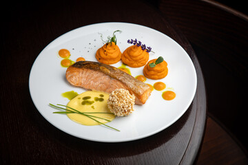Fish dish with garnish on a plate in a restaurant

