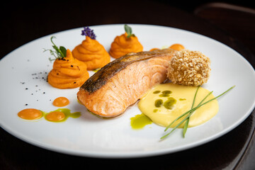 Fish dish with garnish on a plate in a restaurant
