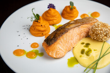 Fish dish with garnish on a plate in a restaurant
