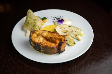 Fish dish with garnish on a plate in a restaurant
