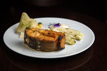 Fish dish with garnish on a plate in a restaurant

