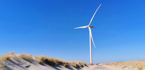 Danish wind turbine at the coastline producing sustainable electricity power