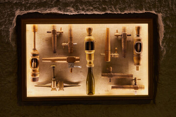 old wooden tools for making wine on a backlit stand