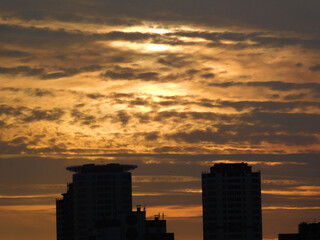 Fototapeta na wymiar Beautiful clouds at sunset over the buildings.
