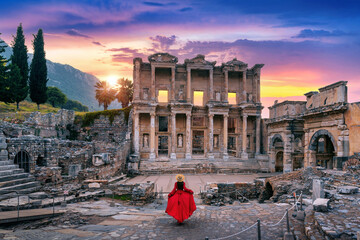 Woman standing in Celsus Library at Ephesus ancient city in Izmir, Turkey. - obrazy, fototapety, plakaty