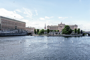 Fototapeta premium Norrström (lake Mälaren's primary outlet in the Baltic Sea in central Stockholm) with the Royal Palace on the left, Sweden's Parliament house and the medieval museum straight ahead.
