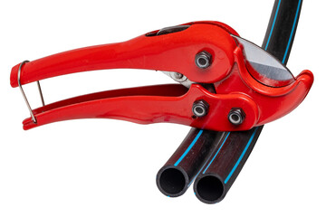 Plumber tools isolated. A red PVC pipe cutter for cutting plastic pipes and two pieces of PE...
