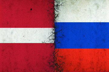 Cracked flags of Russia and Latvia. International political relations. Conflict. Political Economic background.
