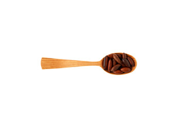 Baru nuts in wooden spoon on white. Baru seeds are highly nutritious and rich in: Antioxidants, mainly tocopherols, protein, dietary fiber, omega-6, omega-3, magnesium, potassium, phosphorus and zinc