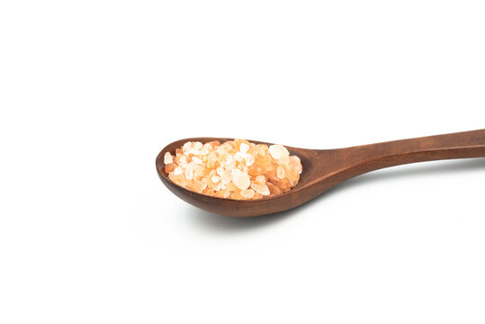 Close-up Wooden spoon have salt hima layan pink color isolated on the white background.