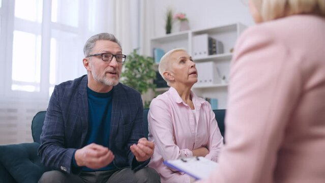 Senior man complaining about his wife at psychotherapist's appointment, therapy