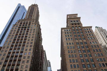 Fototapeta na wymiar The tops of two soaring old skyscrapers