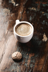Cup of coffee with Amaretti (Italian biscuit) on rustic wooden background. Copy space.