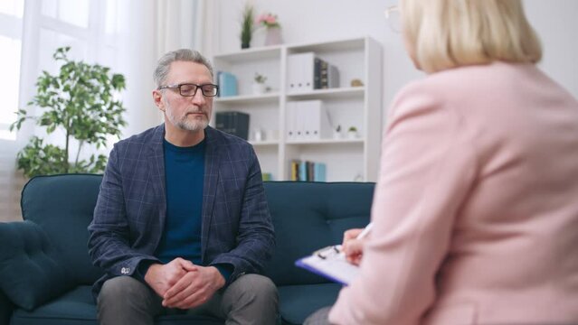 Middle-aged man visiting psychologist, midlife crisis, sharing problems, support