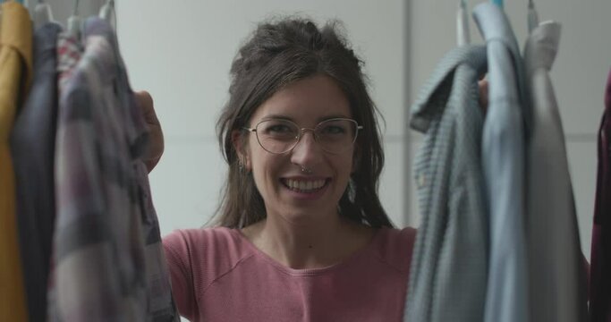 Woman choosing clothes and smiling