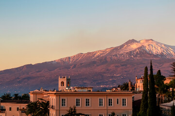Luxury San Domenico Palace Hotel with panoramic view on snow capped Mount Etna volcano at sunrise...