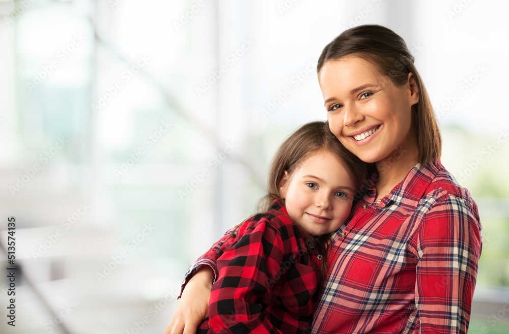 Sticker Mother and her little child happily smile and hug in apartment. Happy family.