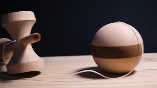 Wooden kendama pan over from ken and spike to striped ball