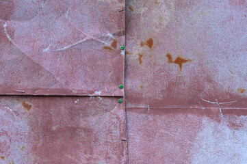 Texture of an old metal fence made of metal sheets.