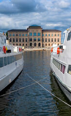 View onto Nationalmuseum at Norrström through a gap between two excursion ships in Stockholm....