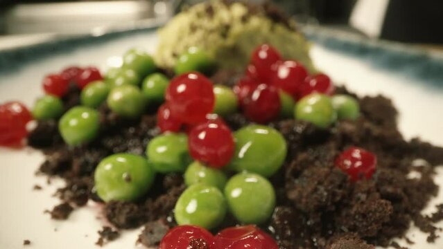 pastry chef pouring sauce cranberry green peas chocolate ice cream sorbet dessert