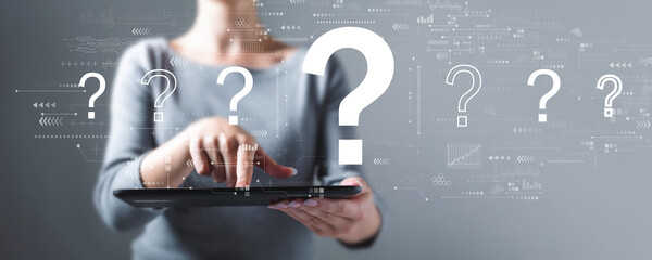 Question marks with business woman using a tablet computer