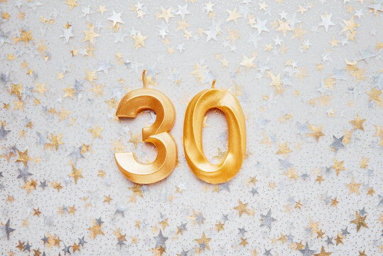 Number 30 thirty golden celebration birthday candle on Festive Background. thirty years birthday. concept of celebrating birthday, anniversary, important date, holiday