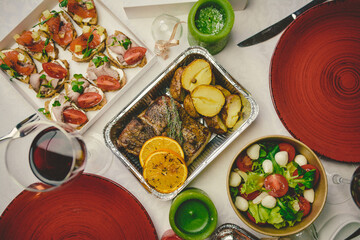 Festive table with meat and baked potatoes