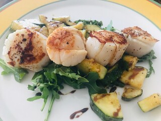 Pan Seared Scallops with zucchini and Arugula.