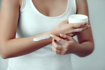 Beautiful Woman Hands. Female Hands Applying Cream, Lotion. Spa and Manicure concept. Girl hands with french manicure. Soft skin, skincare concept. Hand skin care.