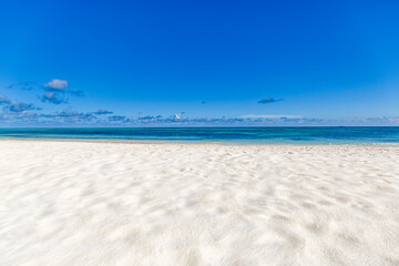 Obraz premium Closeup sand beach sea waves and blue summer sky. Panoramic beach landscape. Empty tropical beach and seascape, horizon. Bright exotic coast calmness, tranquil seaside nature view relaxing sunlight