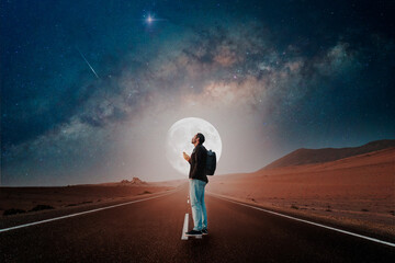 person standing on the road in the desert with full moon and milky way background
