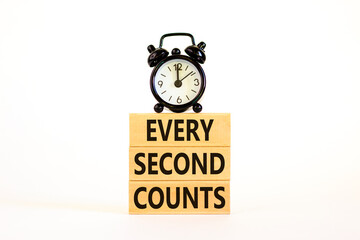 Every second counts symbol. Concept words Every second counts on wooden blocks on a beautiful white table white background. Black alarm clock. Business, motivational and every second counts concept.