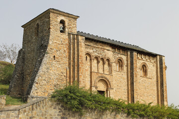 Fototapeta na wymiar View of the church of San Miguel in Corullon, Leon (Spain). Built at the beginning of the 12th century, in the Romanesque style. It has a single nave with three sections topped by a semicircular apse