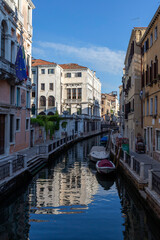 Fototapeta na wymiar Narrow canal in Venice on a summer morning