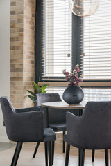 Coffee table with candles by the window of the hung blinds