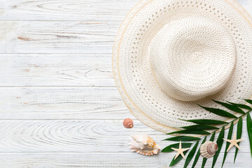 Fototapeta na wymiar Summer holidays. Summer concept with straw hat and tropical leaf. Flat lay, top view, copy space