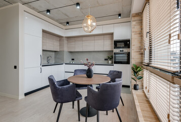 kitchen and dining table near the window in a modern interior in loft style