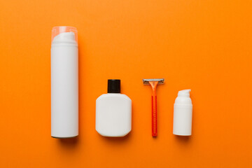 shaving man set. shaving machine, towel, lotion and shaving foam on colored background. Men bath Accessories top view