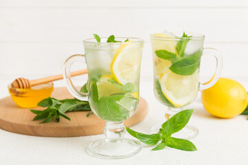 Mojito cocktail. Refreshing mojito cocktail with lime, lemon and mint in a tall glass with a stick