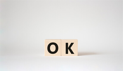 Ok symbol. Concept word Ok on wooden cubes. Beautiful white background. Business and Ok concept. Copy space.